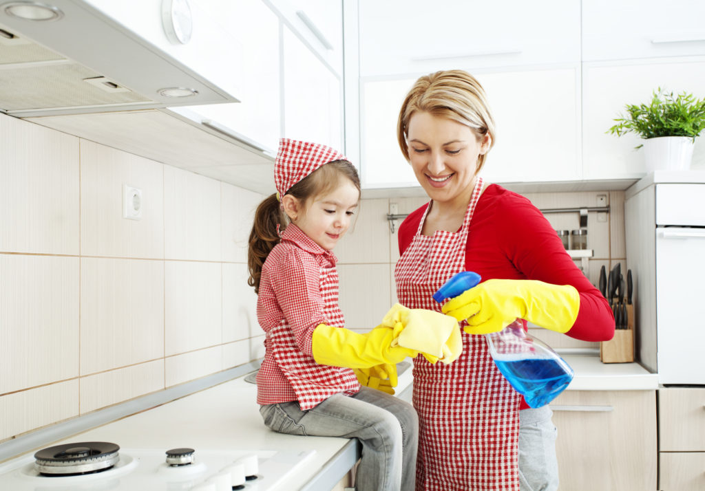 Mother and daughter cleaning in the kitchen
